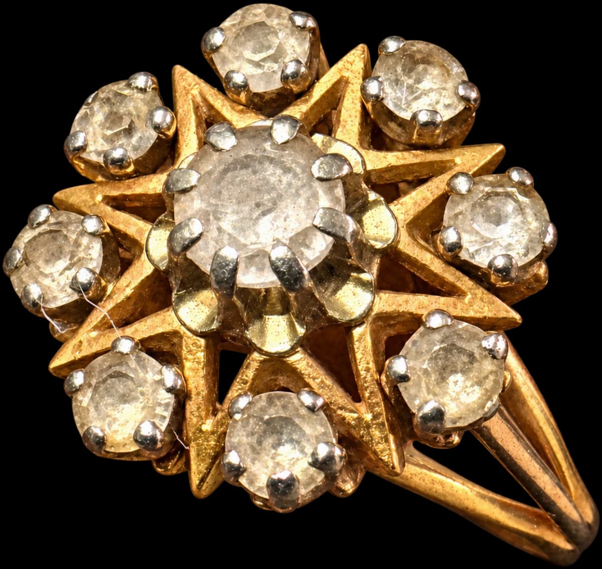 Gold flower cluster ring with a central stone surrounded by eight smaller stones