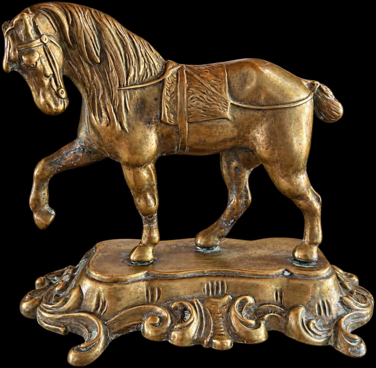 Gold-tone decorative horse with one raised leg on a scrolling ornamental base