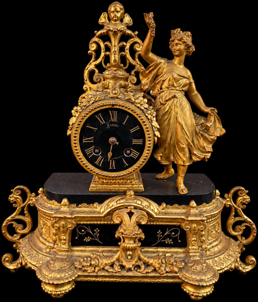 Gilt mantel clock with a standing female figure, black dial and ornate base