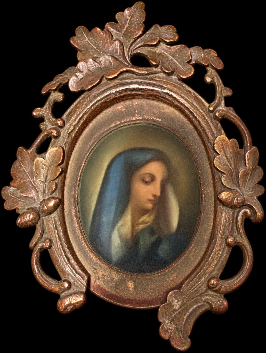 Portrait of a veiled woman in a patinated metal oval frame with leaf decoration